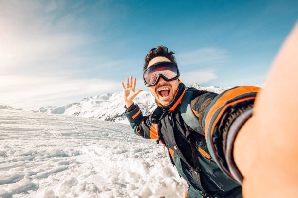 Skier selfie on a snowy mountaintop