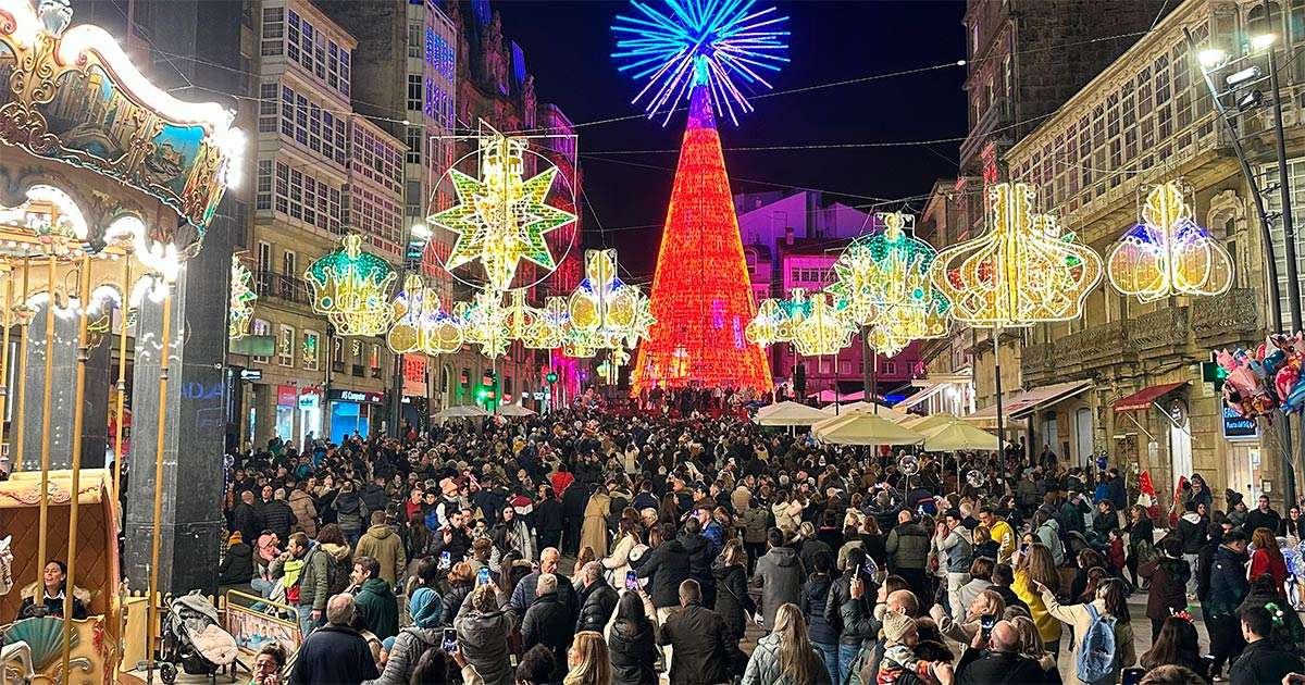 Vigo city street at night with a large illuminated red Christmas tree and festive lights